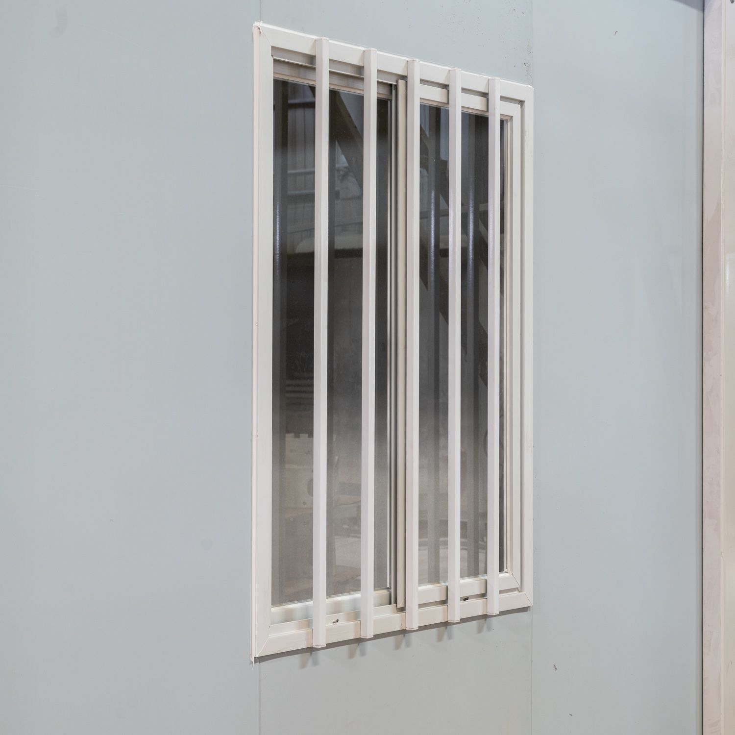 Supplier sample exterior barred window on a light-gray modular wall